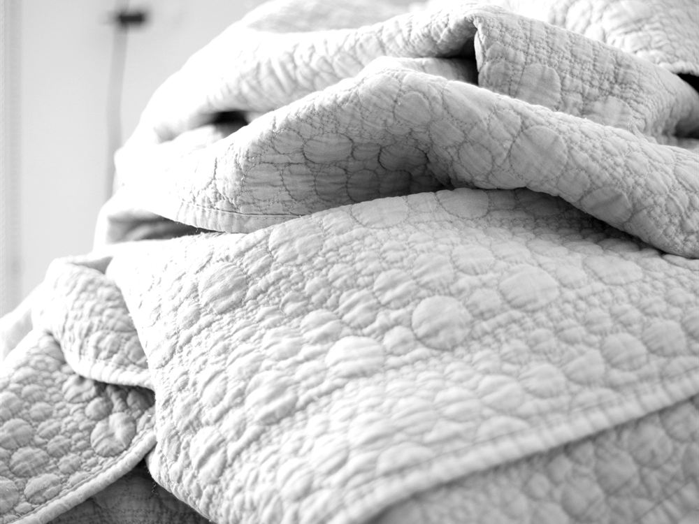 Finished quilts, stacked